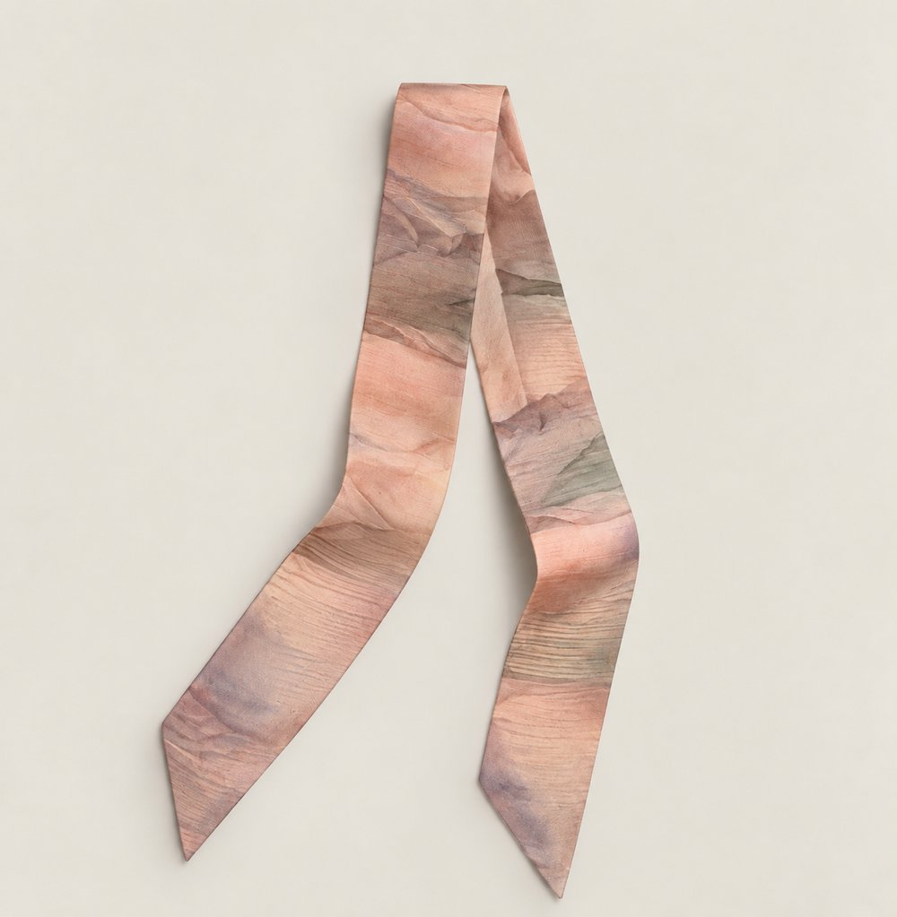 A silk twilly in warm dune tones of rose, sand and lavender
